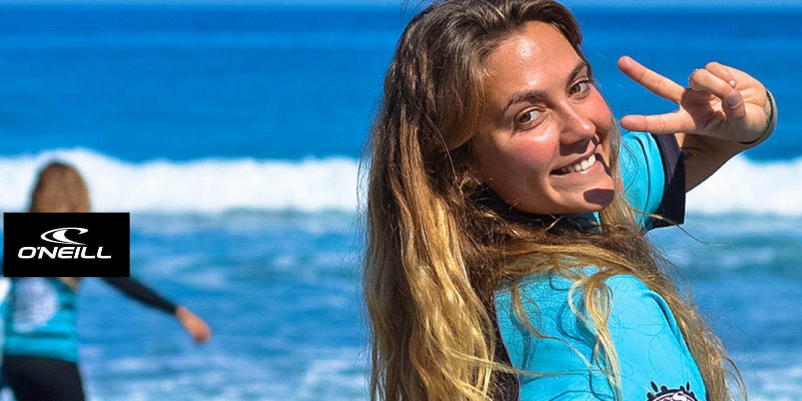 Student smiling during a surf lesson with Blackstone Surf Center in Playa las Américas in Tenerife