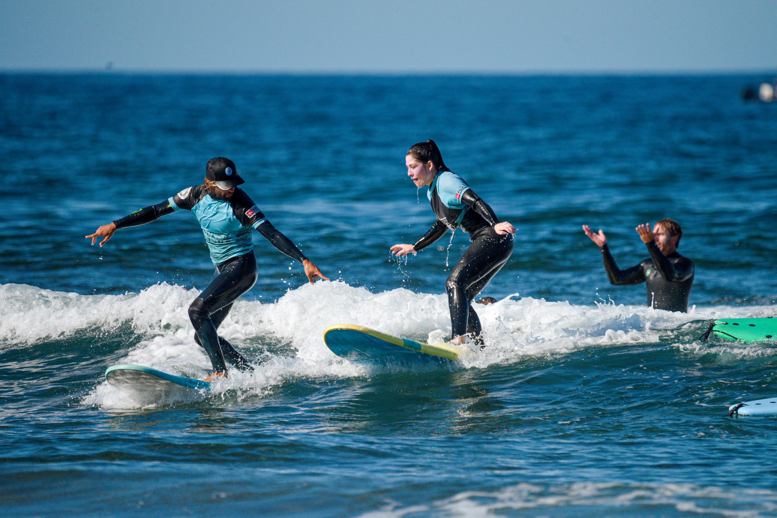 Blackstone Surf Center beginner student surfing with instructor in Playa las Américas in Tenerife during a surf lesson