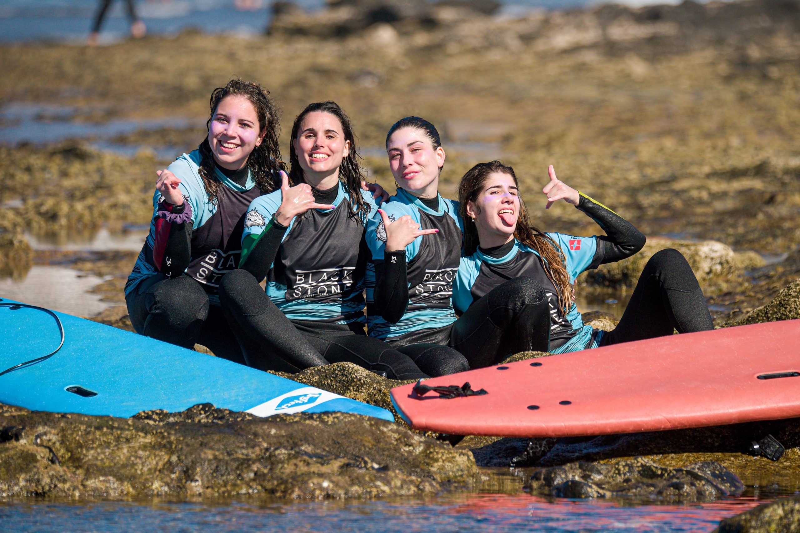 Blackstone Surf Center students smiling in Playa las Américas in Tenerife after a surf lesson