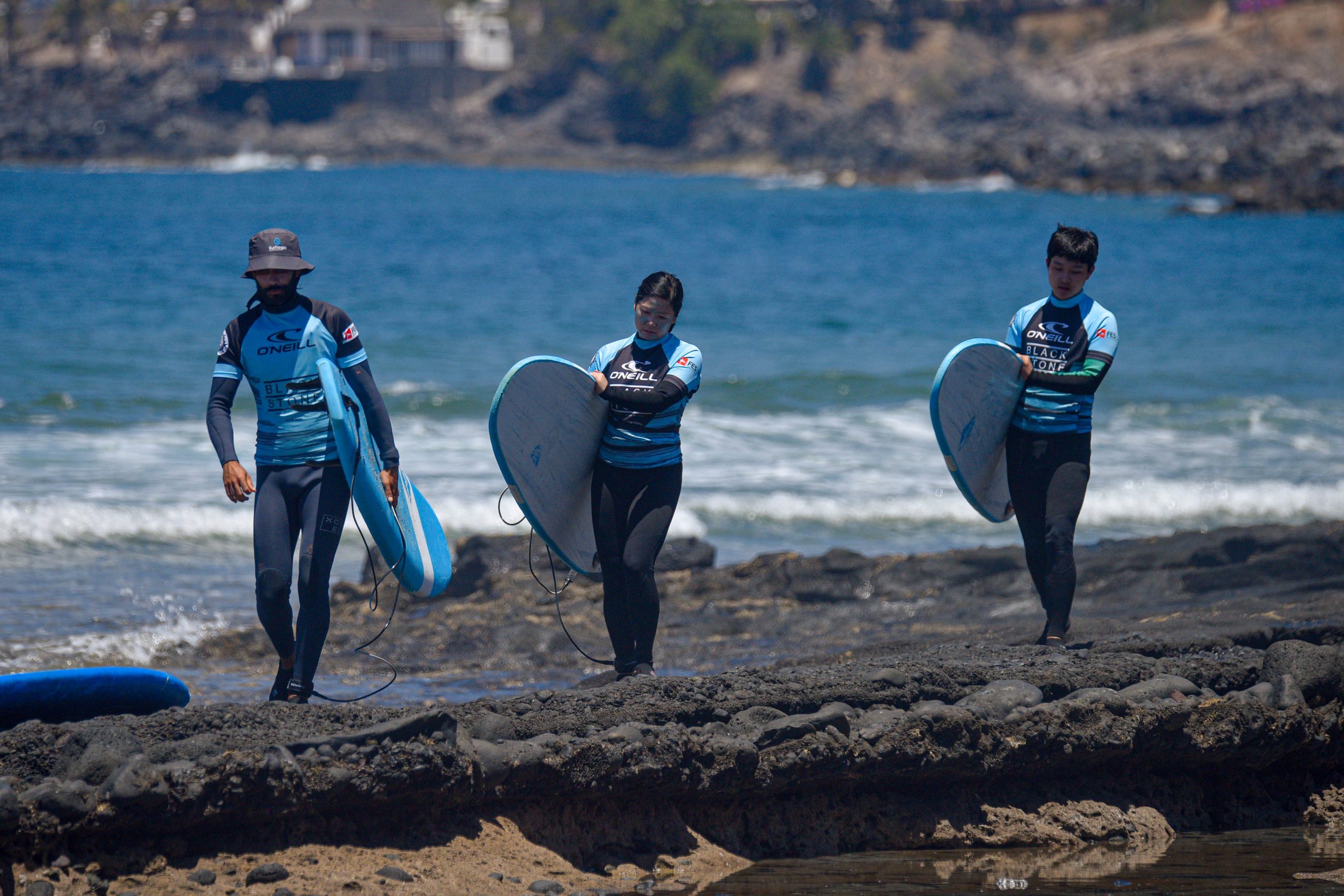 Blackstone Surf Center instructor giving a surf lesson in Playa las Américas in Tenerife to a group of people