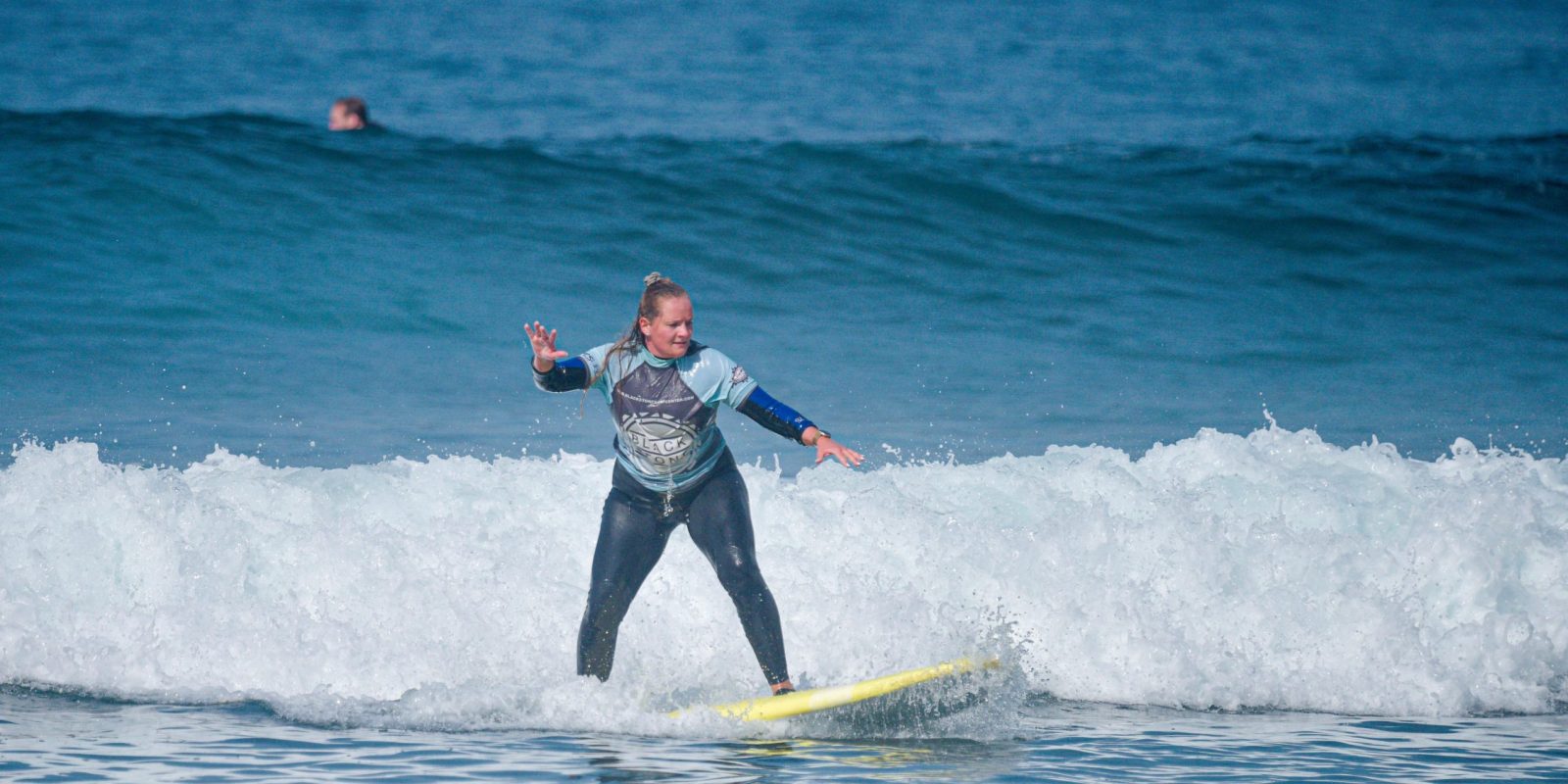Blackstone Surf Center student surfing in Playa las Américas in Tenerife during a surf lesson